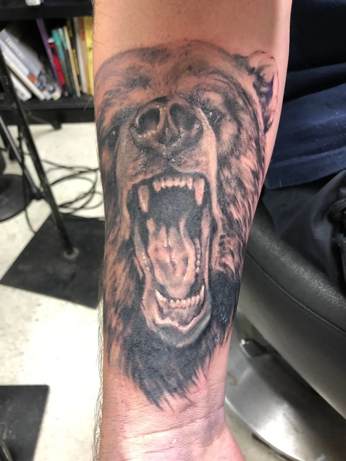 Black and grey roaring bear tattoo with open jaws and textured fur detail
