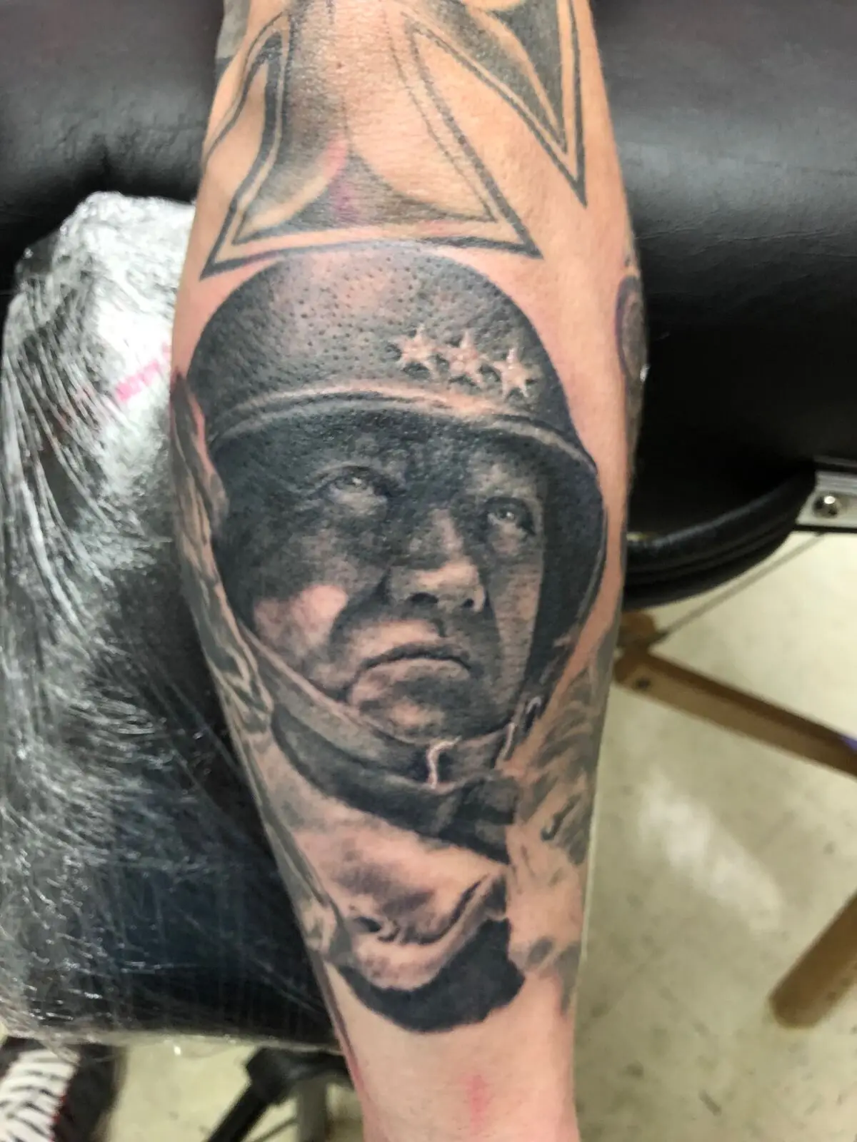 Black and grey realism portrait of General Patton on lower leg
