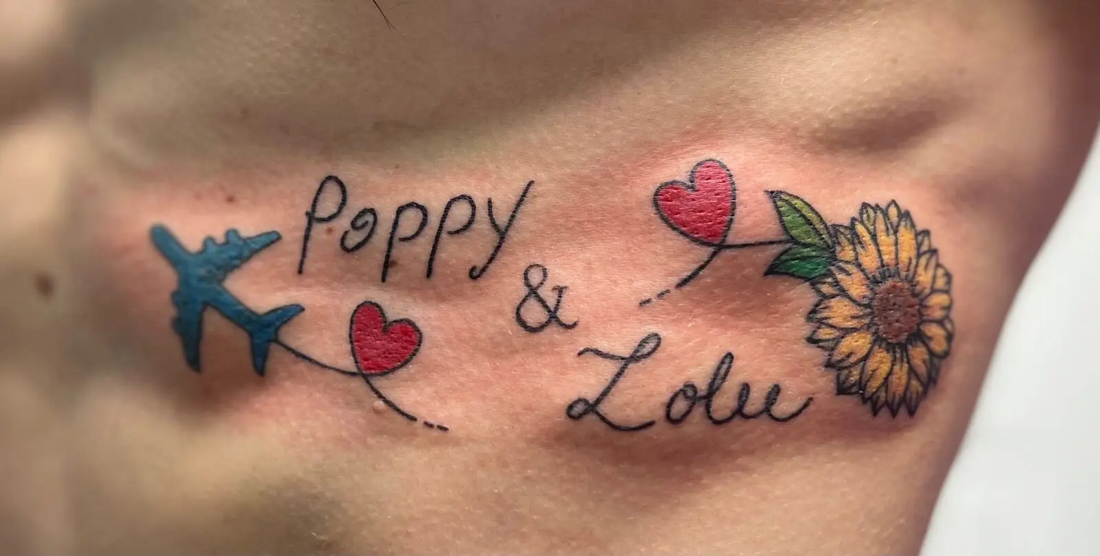 Color sternum script tattoo reading Poppy and Lolu with a blue airplane, hearts, and a sunflower
