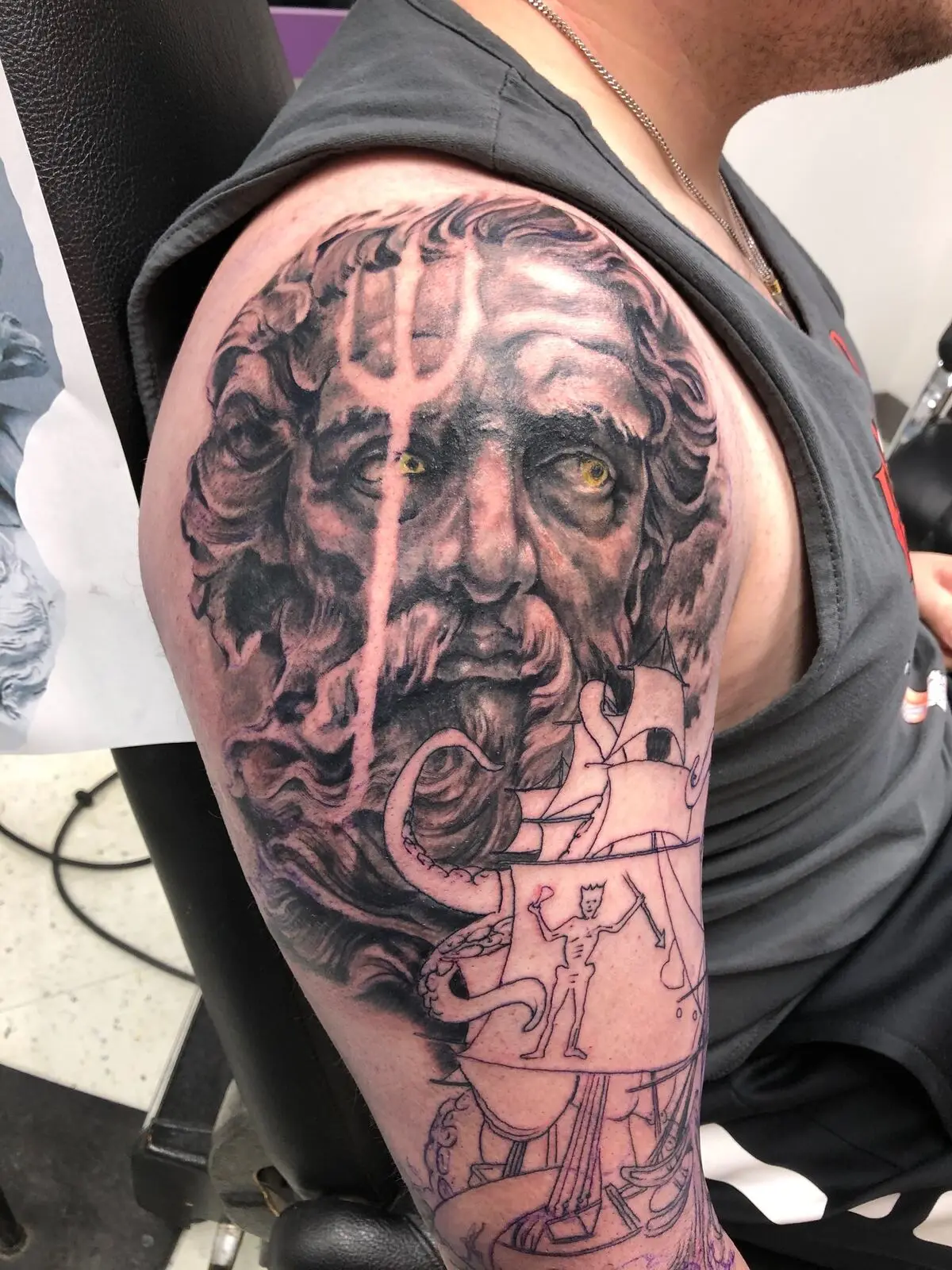 Black and grey Poseidon bust with trident in progress on shoulder cap