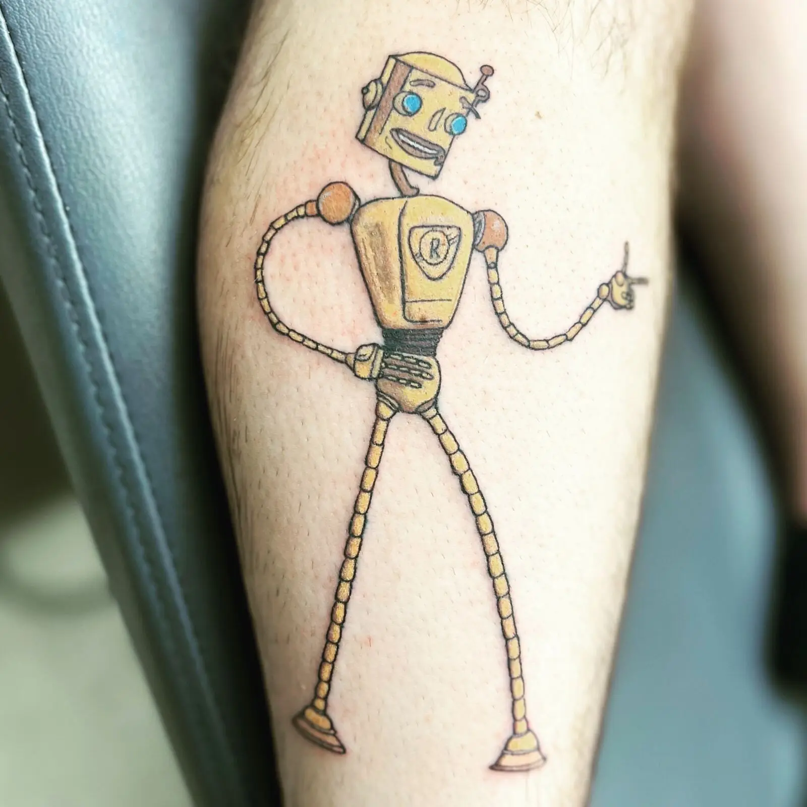 Color cartoon tattoo of Rodney Copperbottom from the Robots movie on the calf