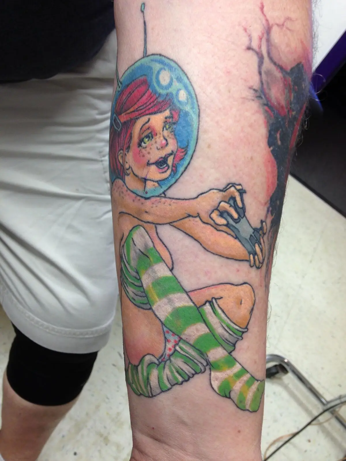 Healed photo of color illustrative space-girl tattoo on forearm
